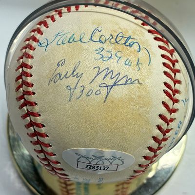 Sale Photo Thumbnail #102: Autographed baseball signed by Steve Carlton and Early Wynn, encased in a clear protective display cube with a JSA authentication sticker.