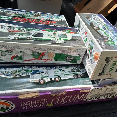Sale Photo Thumbnail #47: Collection of vintage collectible Hess toy trucks and vehicles in original boxes, including Helicopter and Race Car models.