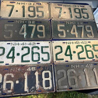 Sale Photo Thumbnail #22: Collection of eight vintage New Hampshire license plate pairs dating from 1931 to 1948, showing heavy weathering and age-related patina.