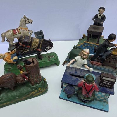 Sale Photo Thumbnail #51: Collection of five antique cast iron mechanical banks with painted finishes, showing varying degrees of wear and paint loss.