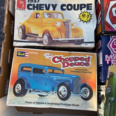 Sale Photo Thumbnail #125: Vintage AMT and Revell 1/25 scale plastic model car kits, including a 1937 Chevy Coupe and a '32 Ford Tudor 'Chopped Deuce' street rod, housed in original boxes displaying shelf wear.