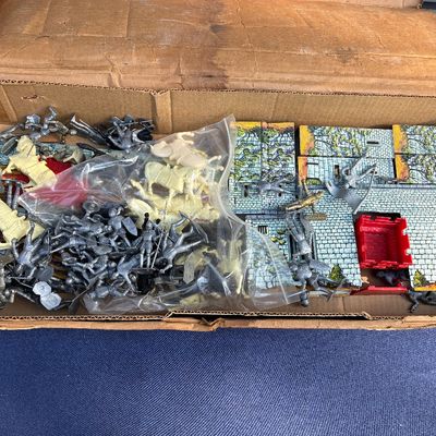 Sale Photo Thumbnail #17: Vintage plastic knight figures and playset castle pieces, stored in a cardboard box.