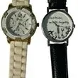 Pair of fashion wristwatches, including a white rubberized chronograph-style watch and a novelty black leather strap watch with jumbled...