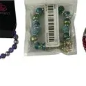 Assortment of four Paparazzi costume jewelry bracelets, including beaded and coil styles in various colors.