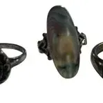Trio of vintage sterling silver and stone rings, featuring a dark oval cabochon setting, a large iridescence abalone or shell focal...