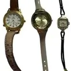 Trio of women's vintage wristwatches, including a brown leather strap watch with Roman numerals, a grey strap watch with a round...