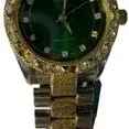 Two-tone ladies wristwatch featuring a green dial, rhinestone-accented bezel and hour markers, and textured gold and silver-tone link...