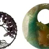 Pair of decorative pendant charms, including a wire-wrapped Tree of Life with purple stone beads and a circular green resin or glass...