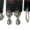 Collection of five pairs of Paparazzi costume dangle earrings, including faux pearl and silver-tone filigree styles on original display...