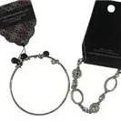 Set of four modern Paparazzi costume jewelry bracelets on original retail display cards, featuring silver-tone chains, geometric links,...