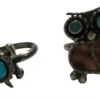 Pair of Southwestern-style sterling silver rings featuring a turtle with turquoise inlay and an owl with stone and shell inlays.