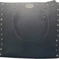 Black Michael Kors leather tote bag featuring pyramid stud trim, top handles, and silver-tone hardware.