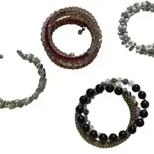 Set of four beaded wrap and coil bracelets featuring various stone, crystal, and metal accents in silver, black, pink, and white tones.