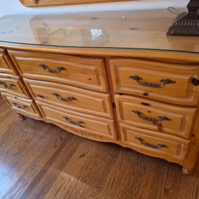 Sale Photo Thumbnail #43: Knotty pine long dresser in a Provincial style with brass bail handles and a protective glass top.