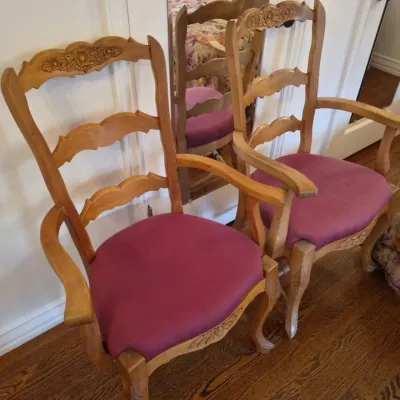 Sale Photo Thumbnail #42: Pair of French Provincial style wooden armchairs with carved floral top rails, ladder backs, cabriole legs, and purple upholstered seats.