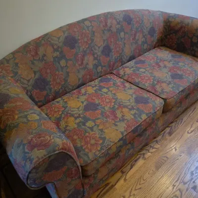 Sale Photo Thumbnail #22: Vintage upholstered sofa featuring a muted floral tapestry pattern and rolled arms.
