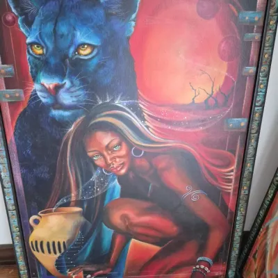 Sale Photo Thumbnail #29: Framed surrealist painting featuring a crouching woman and a large blue panther set against a red background, housed in a thin black frame.
