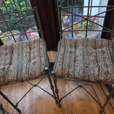 Sale Photo Thumbnail #25: Pair of wrought iron high-back bar stools with cross-brace backs and patterned tufted seat cushions.