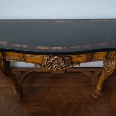 Sale Photo Thumbnail #2: Ornate French Traditional style console table featuring a dark stone or faux-stone top with patterned border inlays and detailed shell-carved wood apron.