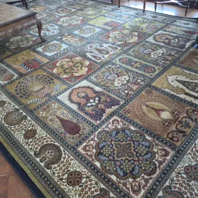 Sale Photo Thumbnail #51: Large Persian-style area rug featuring a grid panel design with intricate floral, paisley, and medallion motifs in earthy tones.