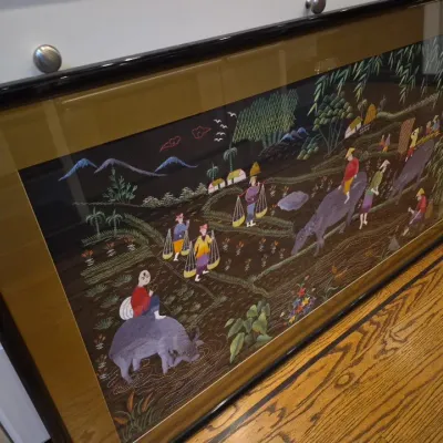 Sale Photo Thumbnail #27: Large framed Asian silk embroidery panel depicting villagers and water buffalo in a rural landscape, set under glass in a black frame with a gold-tone mat.