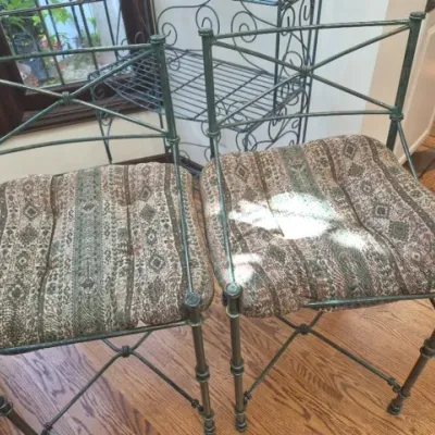 Sale Photo Thumbnail #61: Pair of metal barstools featuring cross-back frames with a distressed green patina and removable patterned fabric cushions.