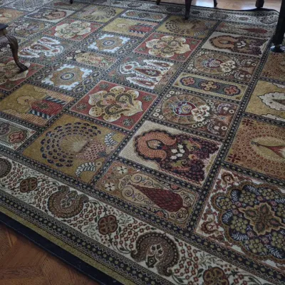 Sale Photo Thumbnail #20: Large area rug featuring a patchwork grid design with Persian and botanical motifs in earthy tones of gold, red, and brown.