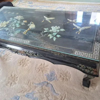 Sale Photo Thumbnail #32: Vintage Asian black lacquer coffee table featuring relief jade and hardstone depictions of cranes and flowers under a glass top.