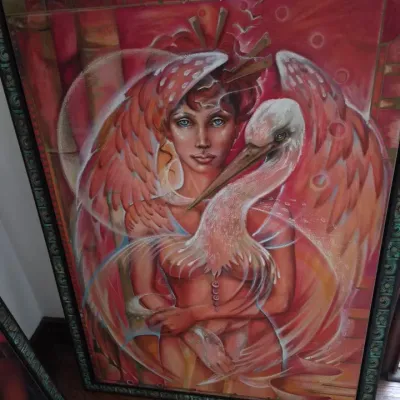 Sale Photo Thumbnail #30: Framed surrealist painting featuring a winged figure and a crane in shades of pink, orange, and red, set in an ornate dark green frame.