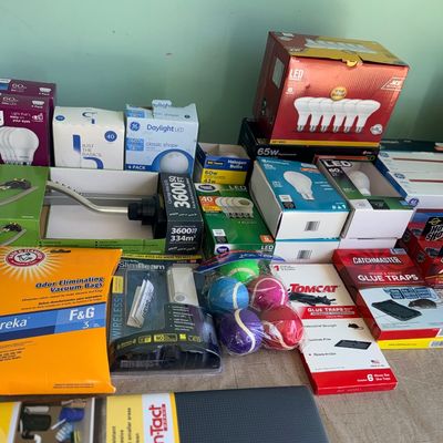 Assortment of household supplies, including LED light bulbs, pest glue traps, vacuum bags, and Con-Tact shelf liner.