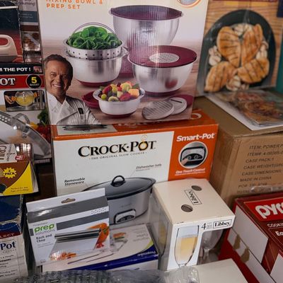 Collection of boxed kitchenware items including a Wolfgang Puck 12-piece mixing bowl and prep set, a Crock-Pot slow cooker, Libbey...