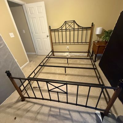 Faux-bamboo metal and wood queen bed frame featuring an arched headboard with geometric lattice details.