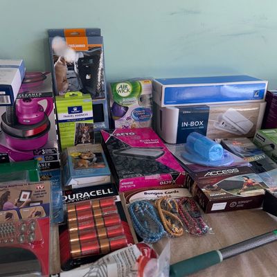 Assortment of boxed household items, pet travel accessories, Duracell batteries, bungee cords, and cleaning supplies.