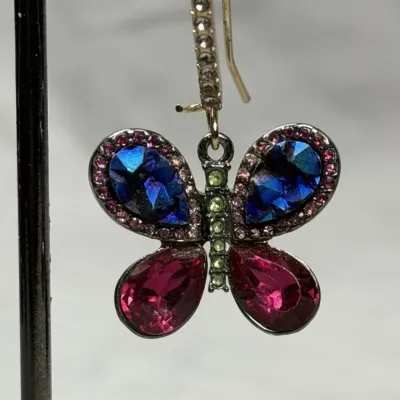 Betsey Johnson dangle earrings featuring mismatched butterfly