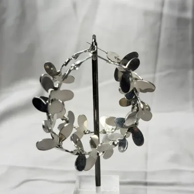 Silver-tone hoop earrings adorned with delicate, petal-like embellishments