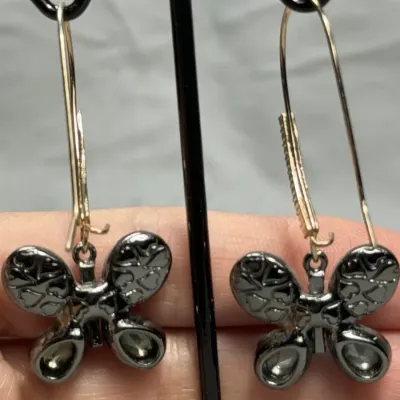 Betsey Johnson dangle earrings featuring mismatched butterfly