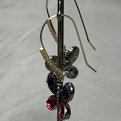 Betsey Johnson dangle earrings featuring mismatched butterfly