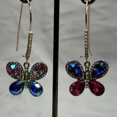 Betsey Johnson dangle earrings featuring mismatched butterfly