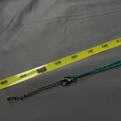 Bohemian-style necklace is a handcrafted piece of natural and dyed stones.