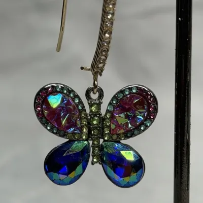 Betsey Johnson dangle earrings featuring mismatched butterfly