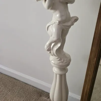 Sale Photo Thumbnail #28: Vintage white glazed ceramic cherub pedestal stand featuring an angelic figure holding an oval bowl.