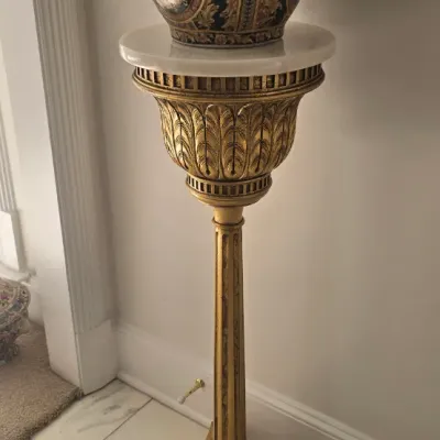Sale Photo Thumbnail #46: Neoclassical style gilt pedestal featuring acanthus leaf motifs and a white marble top, supporting an ornate Asian-style porcelain fishbowl planter with gold gilt details.