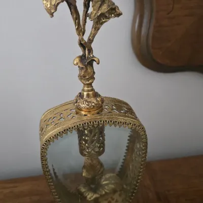 Sale Photo Thumbnail #22: Vintage Ormolu brass and glass perfume bottle featuring a ornate floral leaf stopper and decorative filigree trim.