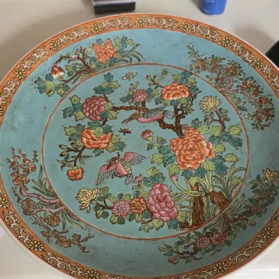 Sale Photo Thumbnail #20: Large turquoise Chinese Famille Rose porcelain charger, featuring detailed hand-painted floral and bird motifs with an ornate patterned border.