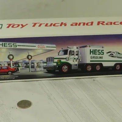 Vintage Hess Toy Truck and Racer set in original packaging, featuring a coin for scale.