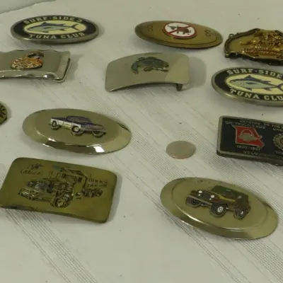 Collection of vintage novelty belt buckles featuring various themes, including trucks, fishing clubs, and advertising graphics.