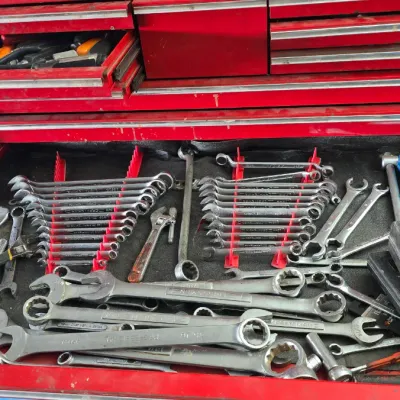 Sale Photo Thumbnail #76: Red Craftsman tool chest filled with various hand tools, including combination wrench sets, adjustable wrenches, sockets, and small tool cases.