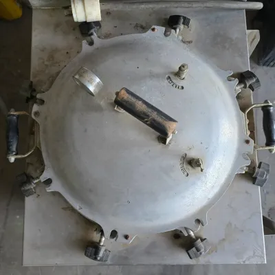 Sale Photo Thumbnail #13: Vintage heavy-duty All-American pressure cooker and sterilizer featuring wing nut clamps, side handles, and built-in safety valves.