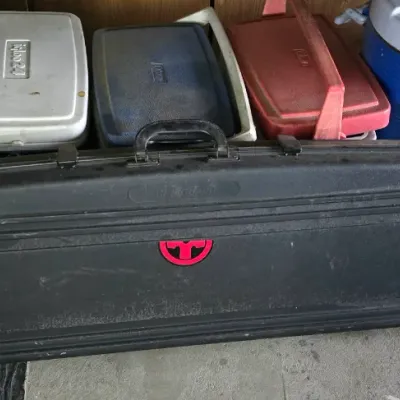Sale Photo Thumbnail #16: Black hard-shell rifle or gun case with a red logo, shown alongside a collection of vintage insulated coolers and beverage jugs.
