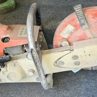 Sale Photo Thumbnail #41: Stihl TS 400 gas-powered cut-off concrete saw with attached diamond blade, showing visible wear and dust from prior use.